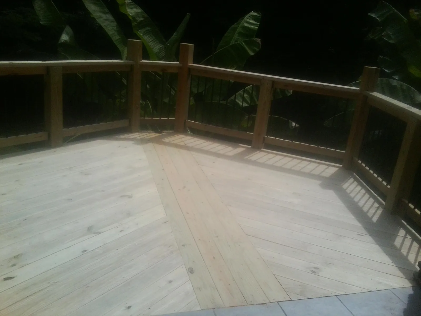 New wood deck and railing built off the back of a home in Chelsea